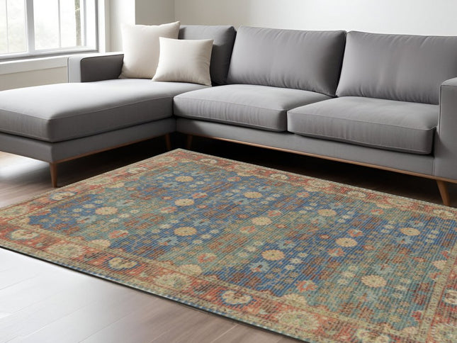 5' X 7' Blue Red And Beige Floral Medallion Hand Woven Distressed Area Rug