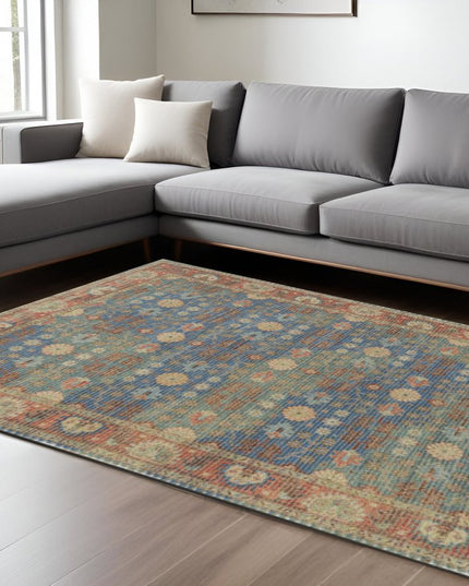 5' X 7' Blue Red And Beige Floral Medallion Hand Woven Distressed Area Rug