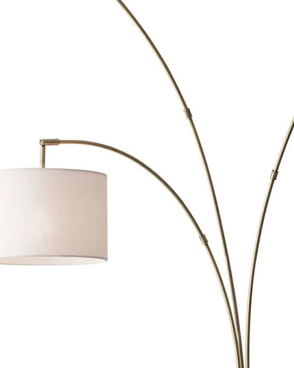 74" Brass Three Light Arc Floor Lamp With Off White Fabric Drum Shade