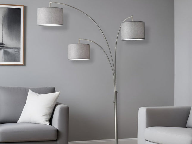 74" Brass Three Light Arc Floor Lamp With Off White Fabric Drum Shade