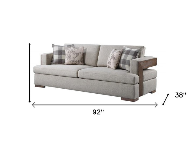 92" Beige Fabric Sofa And Toss Pillows With Brown Legs