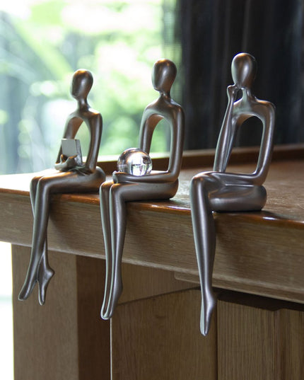 Set of Three Silver Resin People Tabletop Sculpture