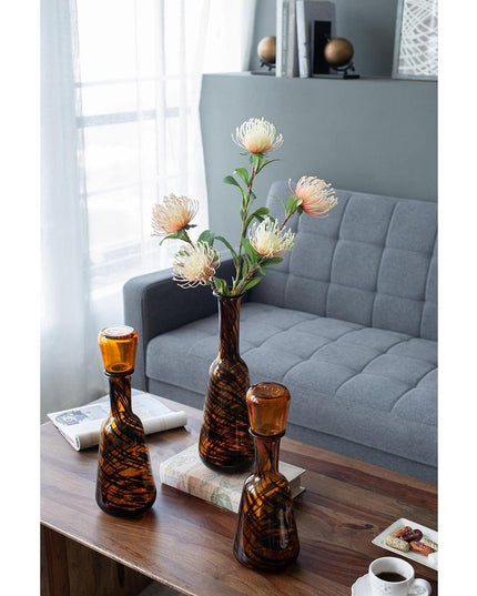 Set of Three Amber Abstract Swirl Glass Decorative Bottles With Stoppers