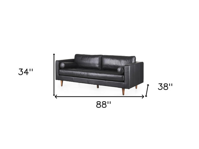 88" Black Leather Sofa And Toss Pillows With Brown Legs