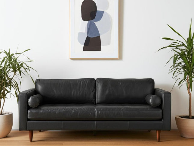 88" Black Leather Sofa And Toss Pillows With Brown Legs