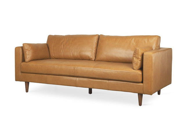 88" Tan Leather Sofa And Toss Pillows With Brown Legs