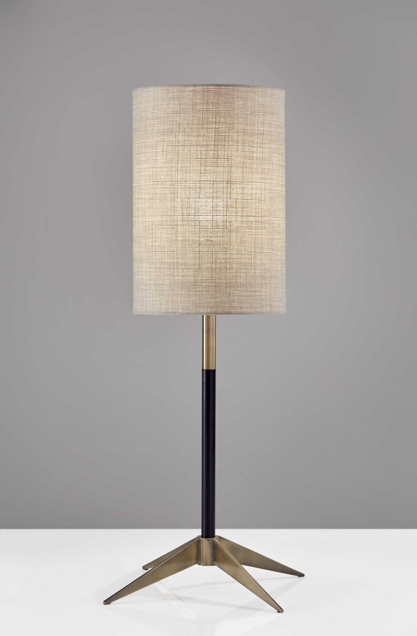 Antique Brass Metal Tripod Base with Matte Black Accent and Tall Natural Fabric Shade Table Lamp